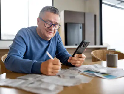 Man paying bills online using phone